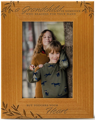 A grandchild is someone who reaches for your hand but touches your heart - Engraved Natural Wood Photo Frame